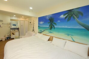 A bedroom with a large bed, a painting of a beach scene, and a bathroom visible through an open door. - HF Keelung (Keelung)