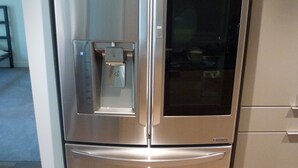 A stainless steel refrigerator with a freezer compartment on top and a bottom freezer, built into a kitchen cabinetry. - New beautiful 2 Bedroom Unit in Biltmore District Walk to Shopping Restaurants (Phoenix)