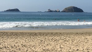 Une plage avec un rivage sablonneux et une mer calme.