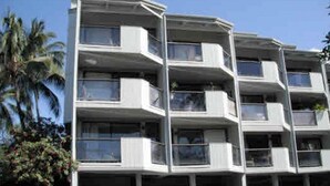 A multi-story building with balconies, likely a hotel or apartment complex. - One Bedroom, First Floor, Fully Furnished Condo (Kailua-Kona)