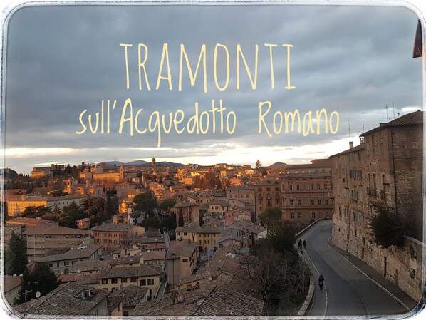 A panoramic view of Tramoniti with historic buildings and a winding road.