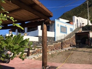 A modern building with a stone foundation and a blue and white facade.