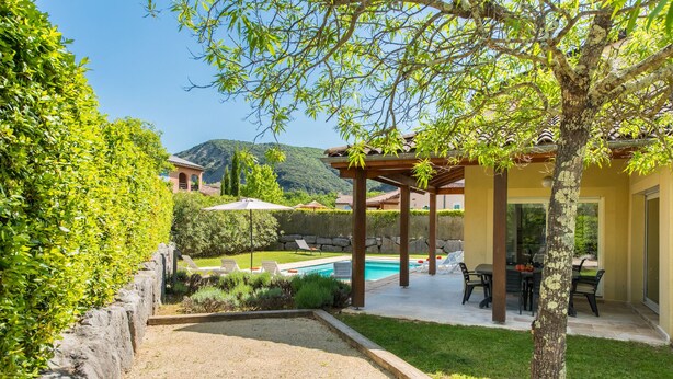 A pool area with lounge chairs, a pergola, and a view of the mountains. - Villa Lune for 10 people with private pool (Vallon Pont D'Arc)
