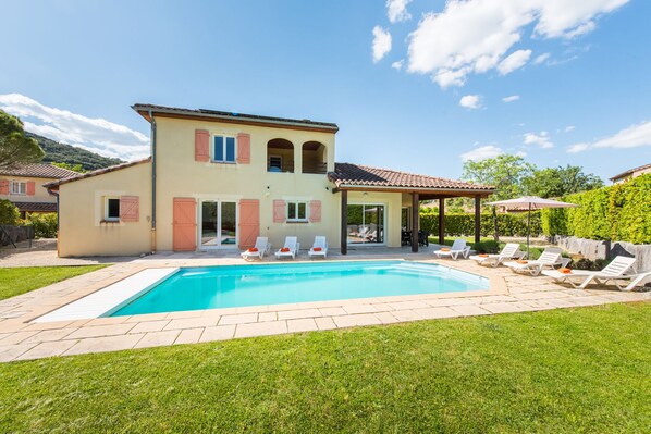 A heated pool, sun loungers