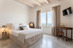 A bedroom with a bed, bedside table, lamp, desk, and a TV. - Alghero Spectacular Villa Carrabufas sea view  near the centre (Alghero)