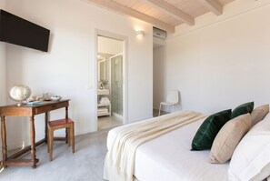 A bedroom with a bed, a desk with a globe, a chair, and a wardrobe.