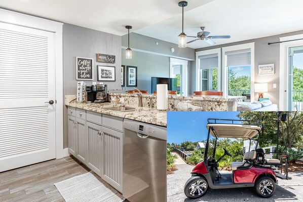 A modern kitchen with a dishwasher, a coffee maker, and a ceiling fan. - Charming Baytowne Wharf 1BR/2BA + Bunk Room — Steps to Village (Destin)