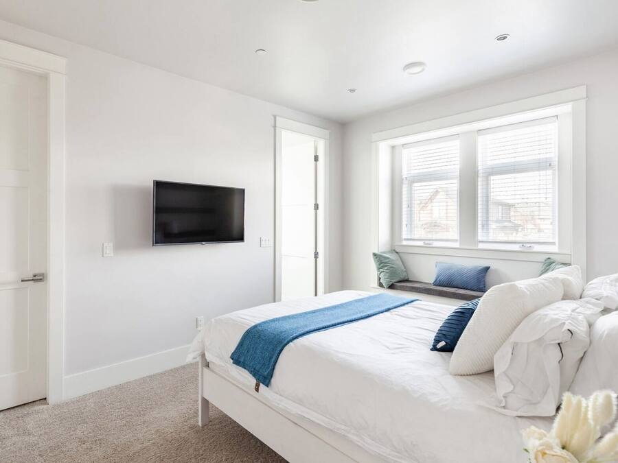 Premium bedding, desk, laptop workspace, blackout drapes