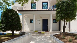 A building with a tiled entrance, a dark door, and a small porch area with steps. - VIKI 1 modern one bedroom apartment for 2 + 2 persons, with pool & sea view (Okrug Gornji)
