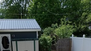 A patio area with four chairs and a fire pit. - Charming, spacious home near towncenter amenities, resturants, trails and parks. (Middlebury)