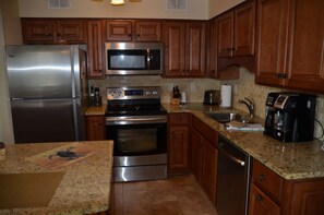 Enjoy cooking in this fully equipped kitchen with a refrigerator, microwave, oven, and dishwasher.