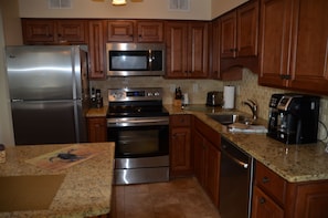 Enjoy cooking in this fully equipped kitchen with a refrigerator, microwave, oven, and dishwasher.