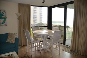 Enjoy stunning ocean views from the balcony, featuring a comfortable seating area with a sofa and chairs.