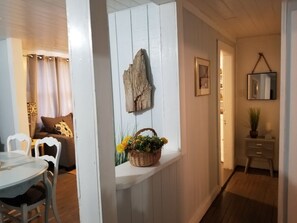 Cozy dining area with a round table and comfortable seating, complemented by natural decor and a functional design.