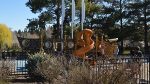 A playground with a large slide and a ship-themed play structure. - West Side Gem │King Beds │Walk Everywhere │Hot Tub │Large Living Spaces (Bend)