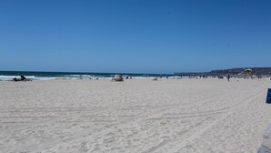 A wide sandy beach with a lifeguard tower and a clear blue sky. - The Beach, Bay and Belmont Park right at your feet-Mission Beach (San Diego)