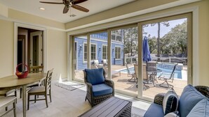 A spacious room with a large sliding glass door leading to an outdoor pool area. - 16 Bittern-3rd Row (85 yards) to the Ocean, Lowcountry home w/ private pool. (Hilton Head Island)