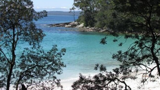 A coastal landscape with clear turquoise waters, rocky shorelines, and dense green foliage. - Waterside, Pet Friendly Beach House (Vincentia)