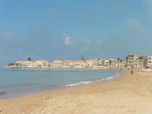 A beach with buildings in the background.