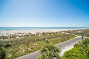 A coastal road leading to a beach with a clear sky. - Seacoast Villa 6 - Unobstructed Ocean View - Elevator (Folly Beach)