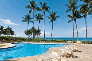 A pool area with palm trees and a view of the ocean. - Wow !!  What a Great View!!--GREAT REVIEWS ! (Wailea-Makena)