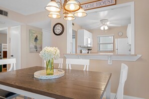 Enjoy a warm and inviting dining experience in this elegant space, complete with a beautifully set table for two.