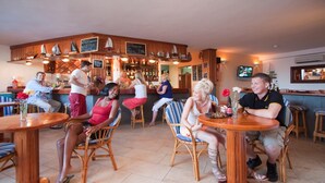 A bar area with wooden furniture and a tiled floor. - Princesa Ico 1 bedroom apts. (Puerto del Carmen)