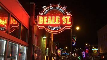 A neon sign for Beale St. Gifts with a circular design and musical notes.