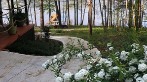 A wooden deck with potted plants, a pathway leading to a lake, and a gazebo. - Lake life at our 4 BR on Lake Hartwell near Clemson University and Anderson, SC (Anderson)