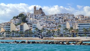 A coastal town with a prominent church on a hill, white buildings, and palm trees along the beachfront. - Costa Blanca, Altea, beautiful apartment with fantastic panoramic views (Altea)