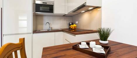 Fridge, microwave, coffee/tea maker, cookware/dishes/utensils