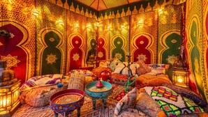A richly decorated room with intricate patterns on the walls and ceiling, a traditional hookah, and a variety of colorful textiles and cushions. - Riad Serpa Galé - Luxury, private pool, AC, wifi and 5 mins from the beach (Albufeira)
