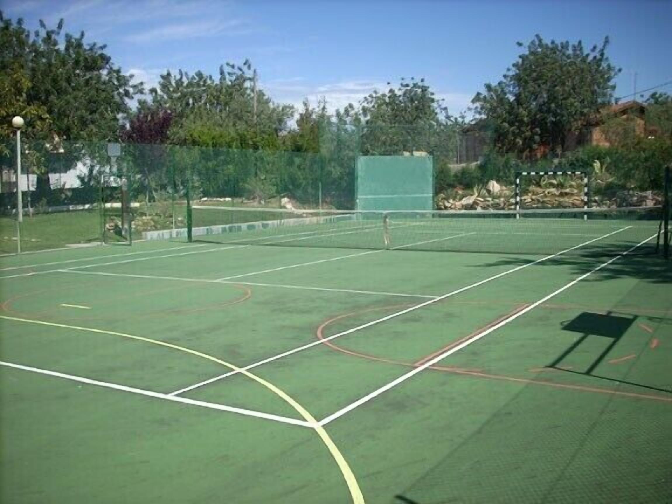 A tennis court with clear boundary lines and a net.