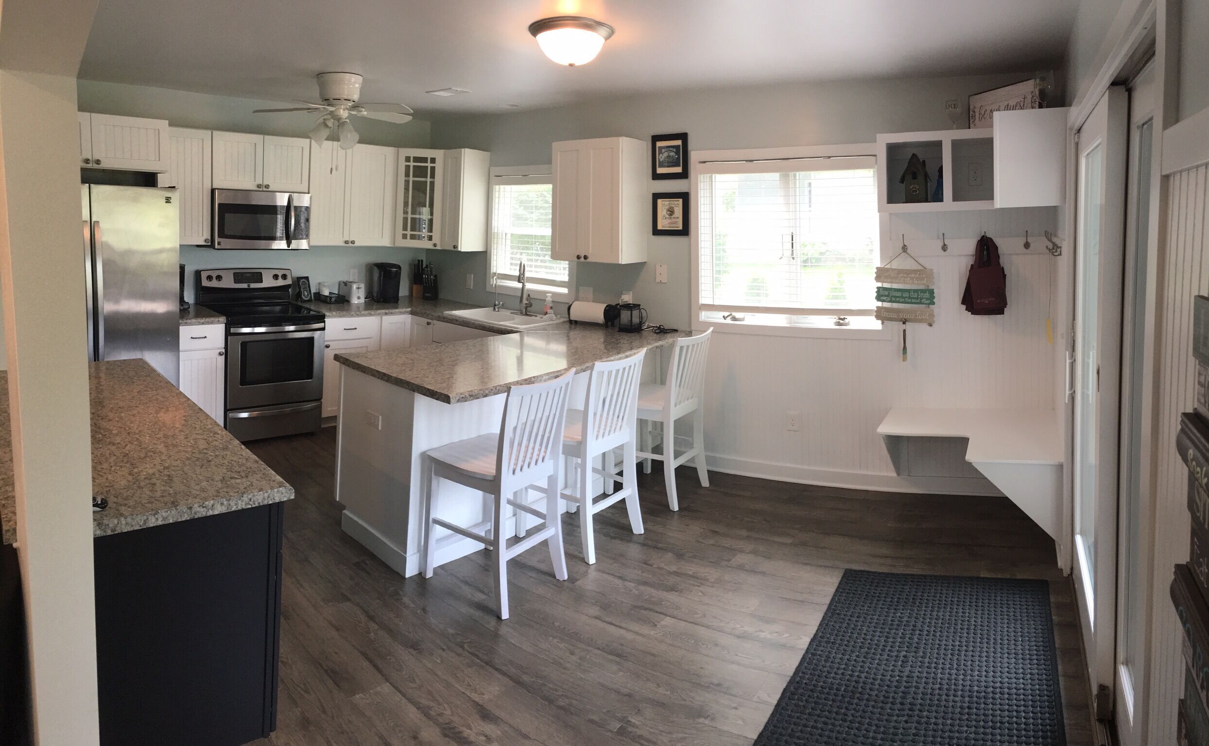 Kitchen with full size fridge, stove, microwave and dishwasher 