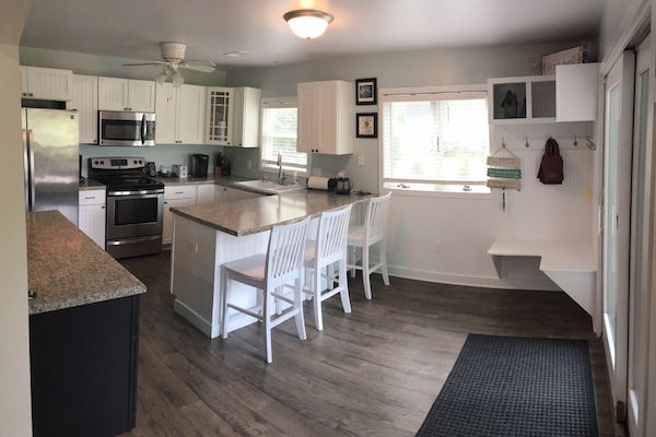 Kitchen with full size fridge, stove, microwave and dishwasher