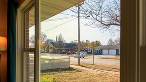 A view from a window overlooking a parking lot with a building in the background. - Oneida St duplex 5 min walk to Lambeau 8 beds furnished full kitchen laundry (Green Bay)