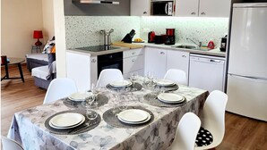 A modern kitchen with white cabinetry, a microwave, a coffee maker, and a dishwasher. - 68 m² *** self-contained apartment, large terrace, parking, surrounded by mountains. (Haute-Garonne)