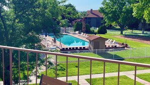 A pool area with lounge chairs and a small pool house. - Sparkling Newly Remod Condo. Near Zion's, Tuacahn, Bike Trails. Pool &Pickleball (St George)
