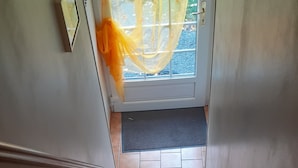 A staircase leading to a door with a yellow curtain. - 2*-rated STUDIO in the countryside, 8 km south of BAYEUX, D-Day beaches. (Trungy)