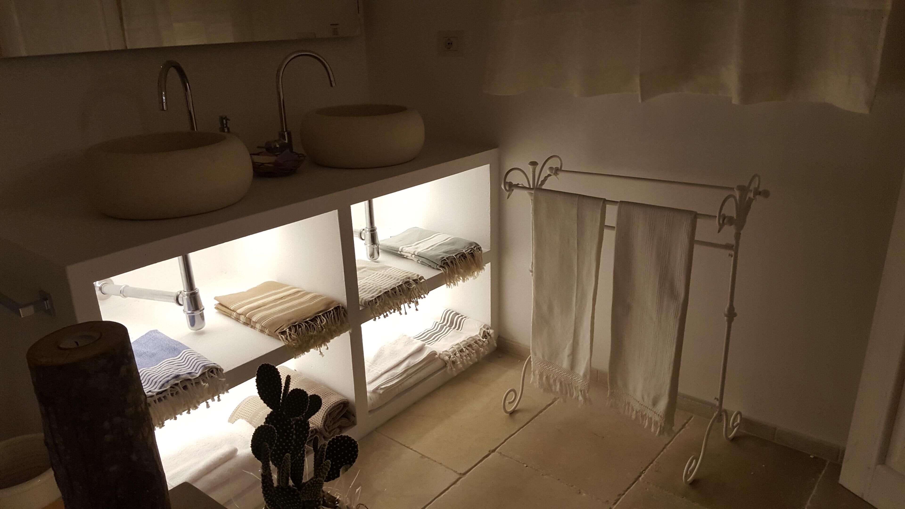 Een bad/douchecombinatie, een bubbelbad, een haardroger, badjassen