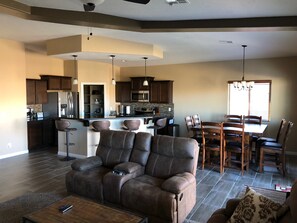Relax in the living area with a comfortable sofa and enjoy meals in the adjacent dining space.