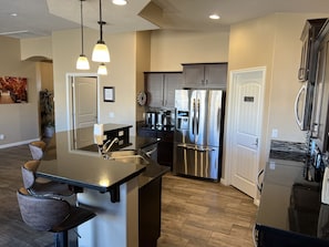 Enjoy cooking in this well-equipped kitchen with a refrigerator, oven, and sink.