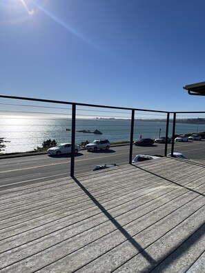 A wooden deck with a view of the sea and parked cars. - Beach House Overlooking Seacliff State Park and Rio Del Mar Beach, Aptos (Aptos)