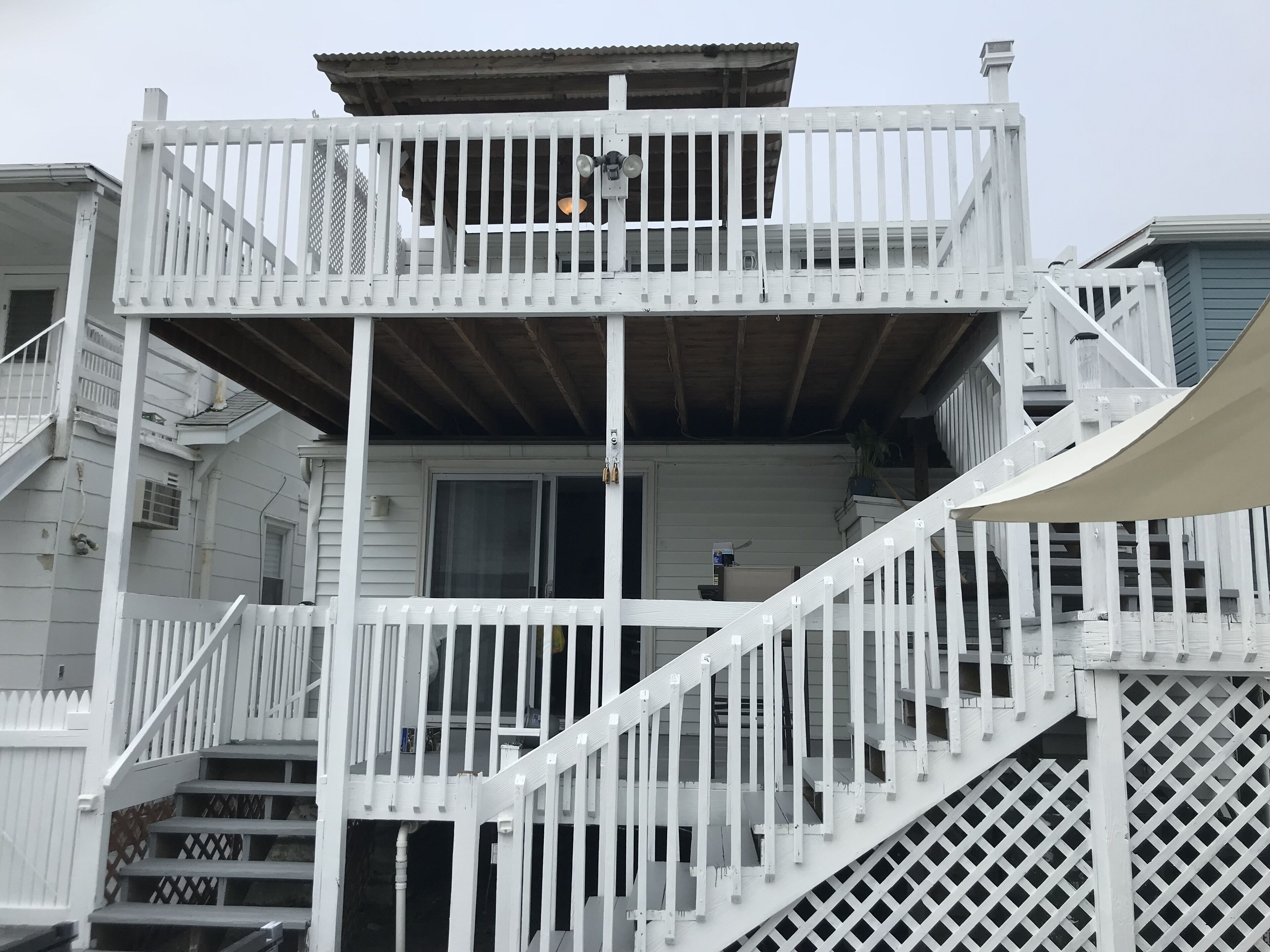 A multi-level wooden structure with a balcony and stairs.