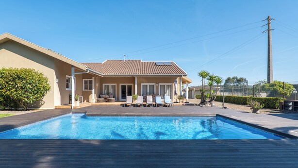A house with a swimming pool, a covered patio, and a tall utility pole. - Luxury villa with pool close to the beach (Póvoa de Varzim)