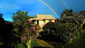 A house with a garden and a rainbow in the background. -  Villa  in Paradise !Mountain Views, Ocean and golf course just  steps away (Princeville)