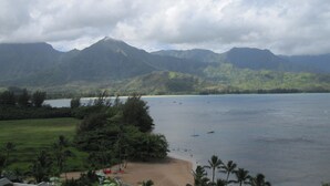A beach with a mountain backdrop, clear skies, and calm water. -  Villa  in Paradise !Mountain Views, Ocean and golf course just  steps away (Princeville)