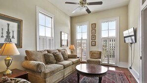 A living room with a sofa, armchairs, a coffee table, and a ceiling fan. - Prime location: Walk to all the French Quarter attractions. Enjoy NOLA with ease (New Orleans)