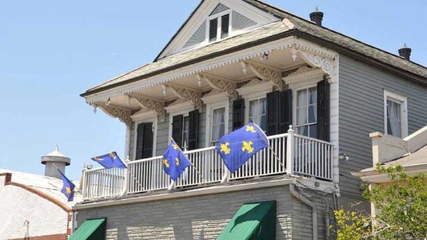 A two-story house with a balcony, white trim, and a small tower-like structure on the roof. - Prime location: Walk to all the French Quarter attractions. Enjoy NOLA with ease (New Orleans)