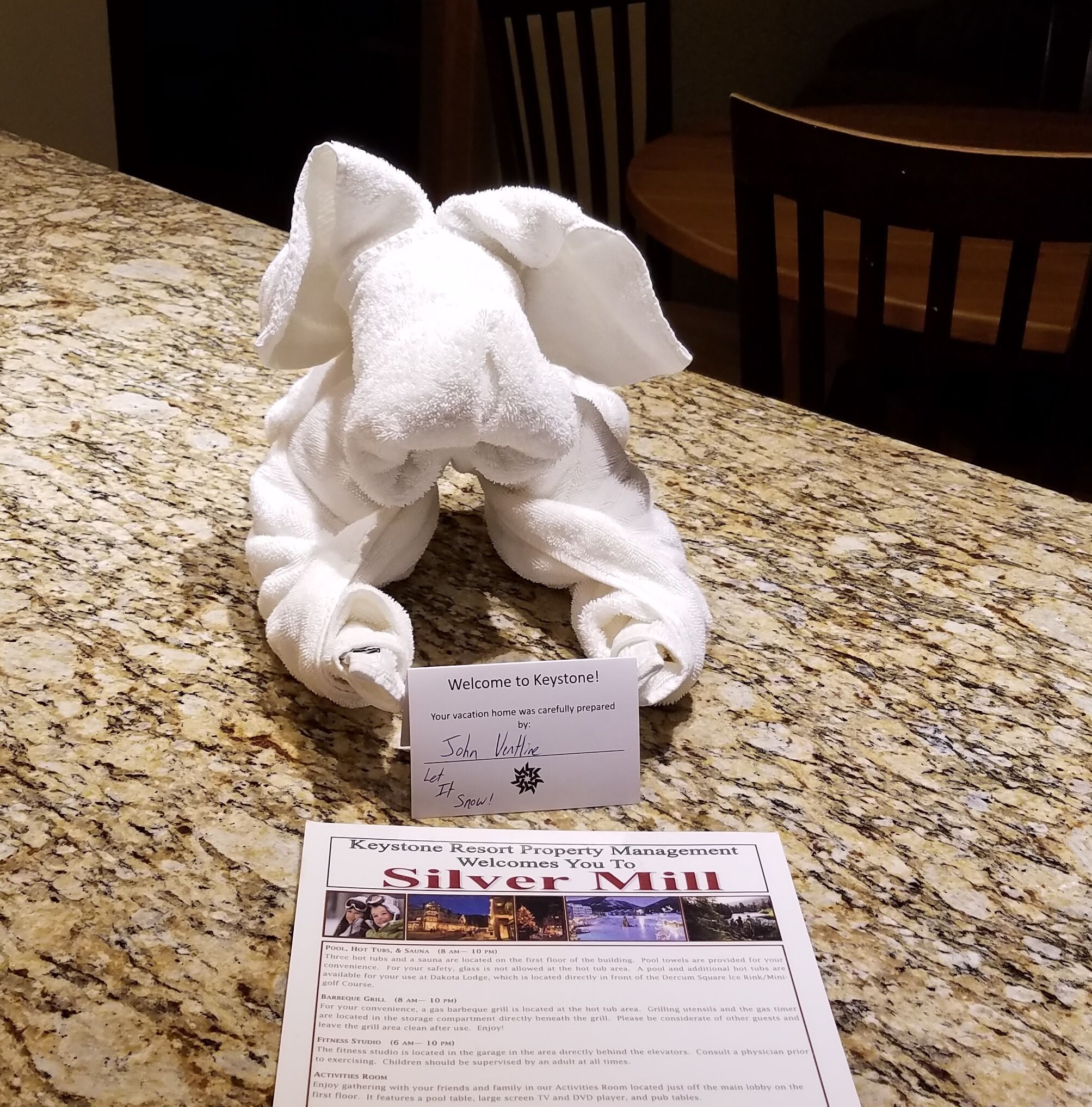 A towel elephant on a granite countertop with a welcome card from Keystone Resort Property Management.